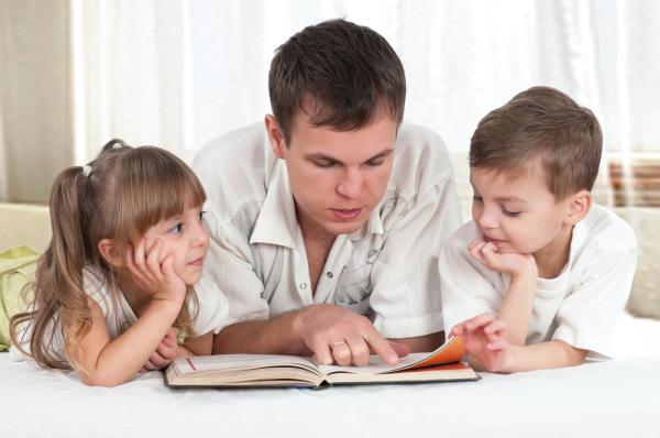 папа читает книгу детям
